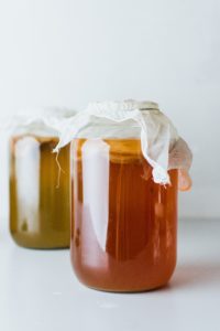 two jars of fermenting kombucha