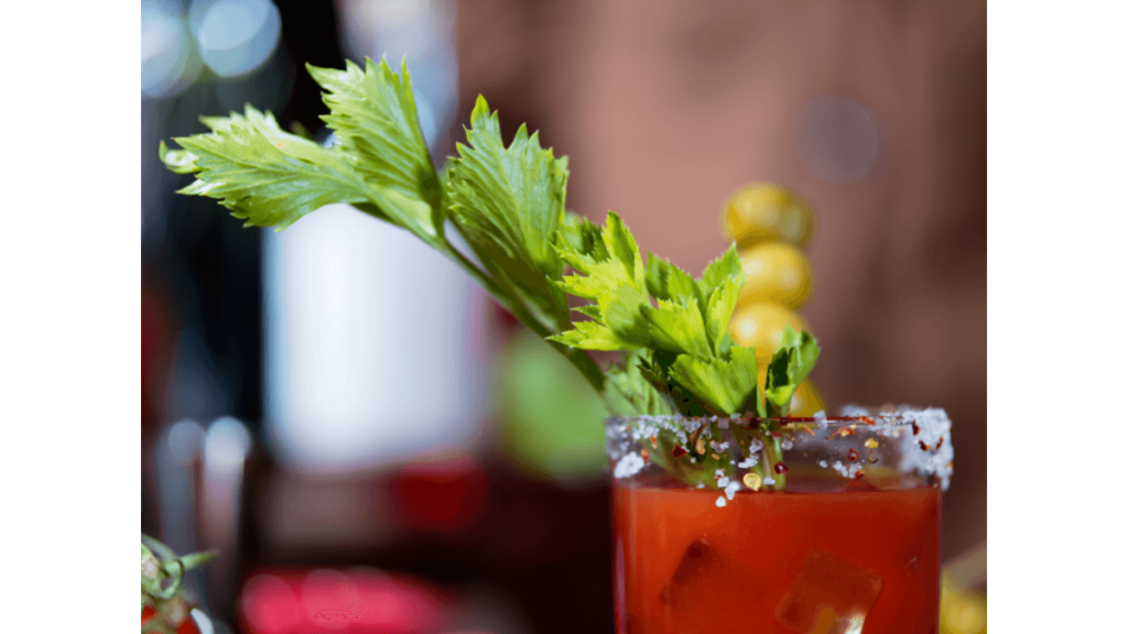 Virgin Bloody Mary garnished with olives, and celery with a salted rim